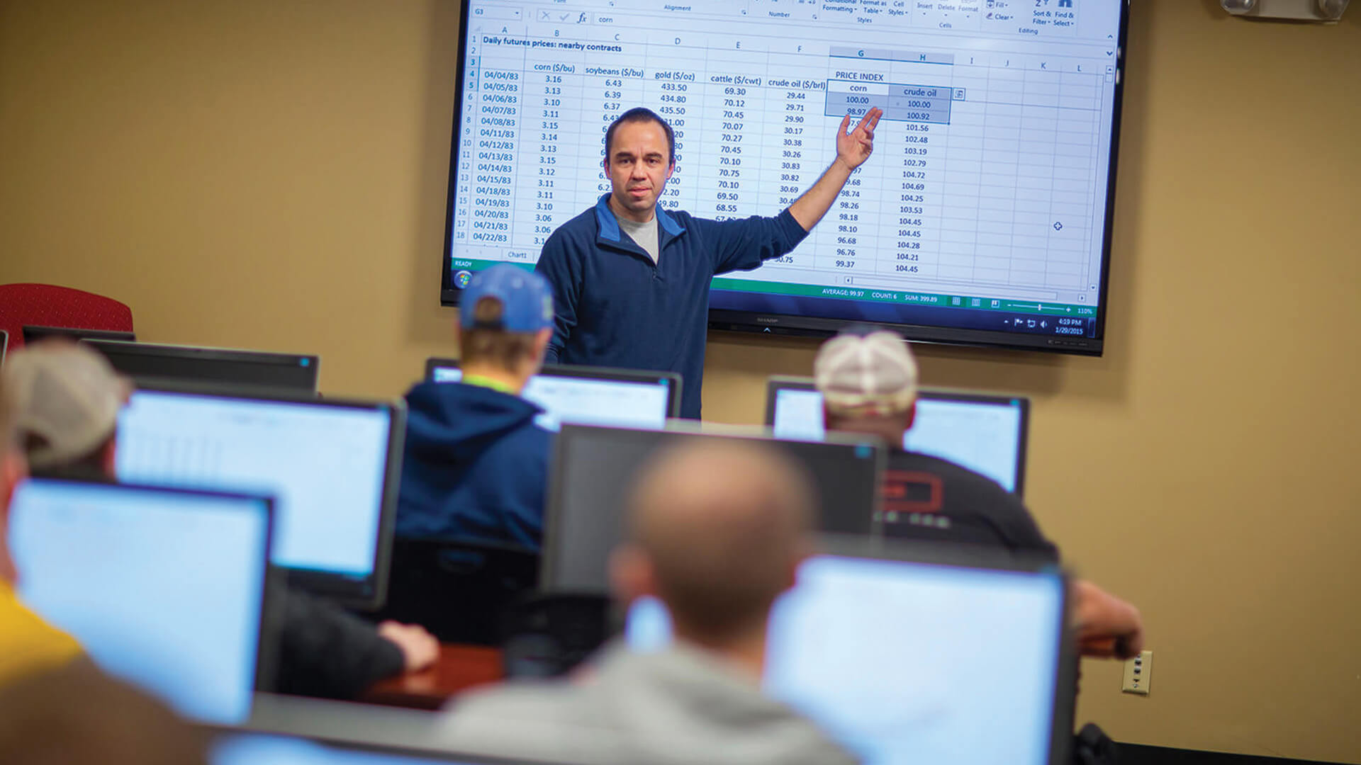 Professor pointing at data on screen